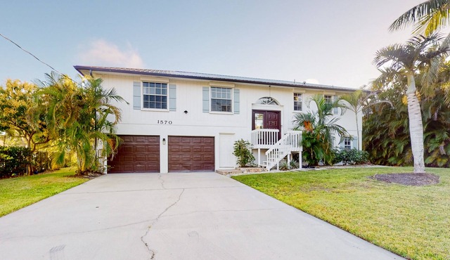 Dog-friendly waterfront home with extensive deck, canal views, lawn, W/D, AC